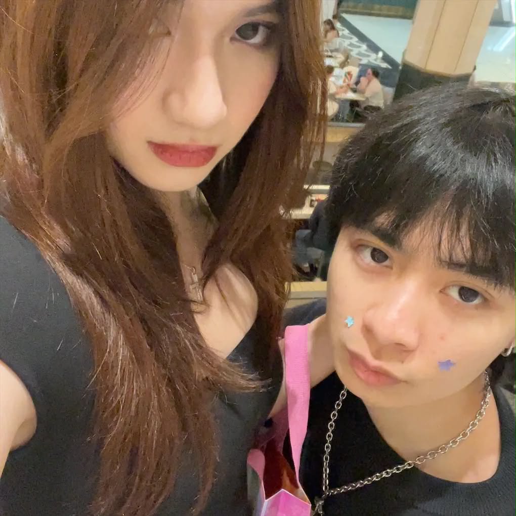 Two people posing closely together for a selfie