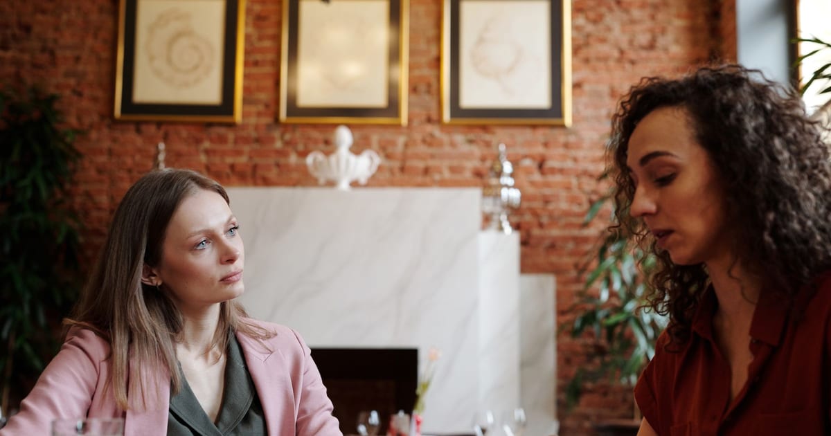 Two friends having a supportive conversation over coffee